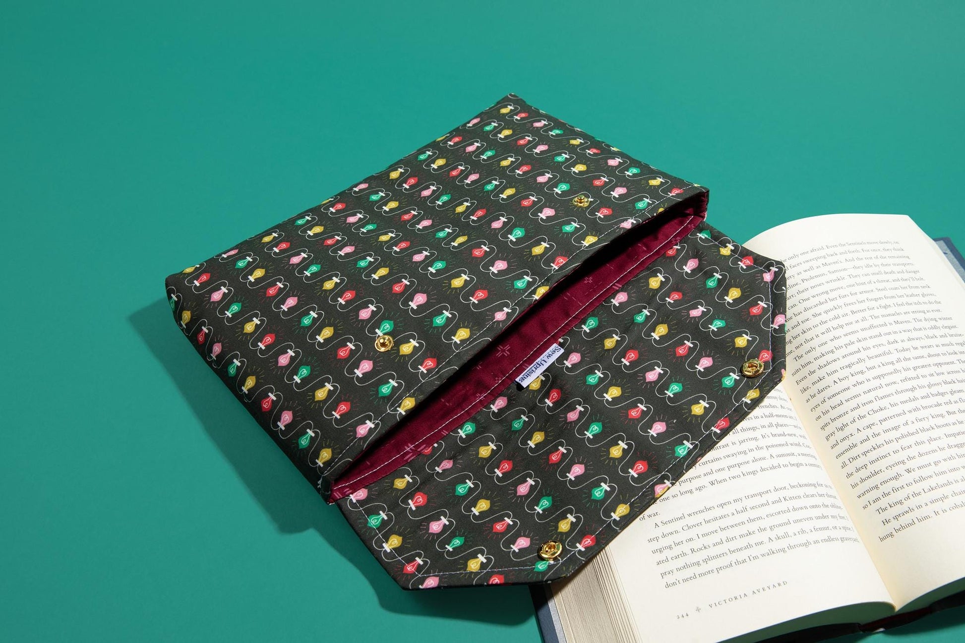 Protective envelope booksleeve with snap closure Full coverage book sleeve with padding Protective kindle case for winter holiday lights